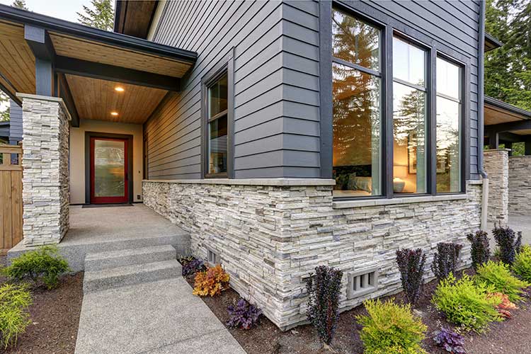 A beautiful home with stone and siding exterior