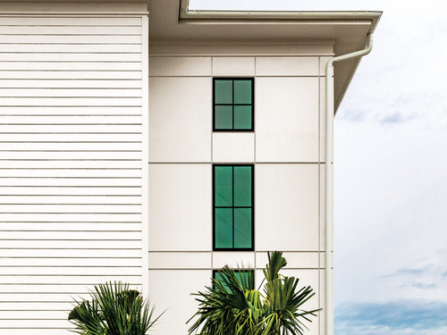 3 story building with white James Hardie Artisan Siding