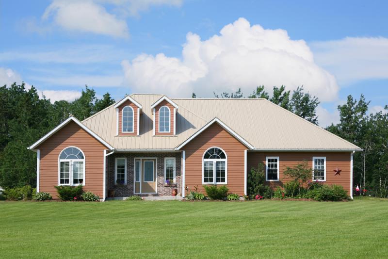 A home with brown vinyl siding and brown brick.