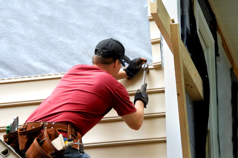 Man installing house siding