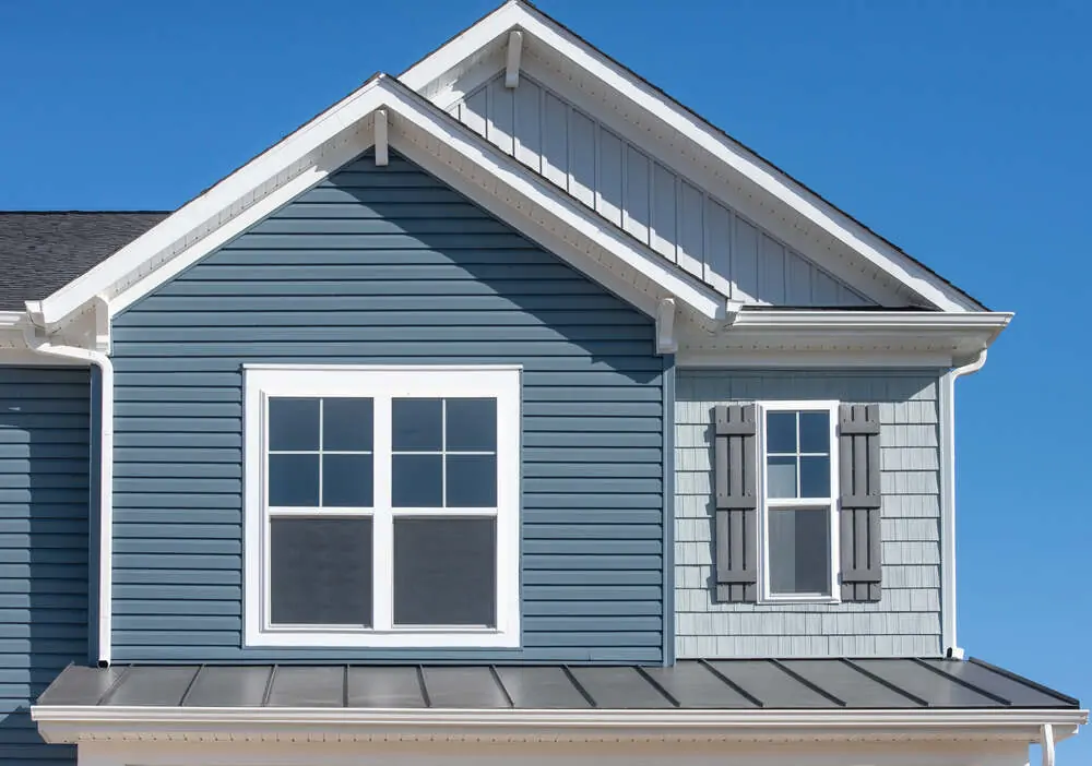 A house with blue horizontal and vertical siding