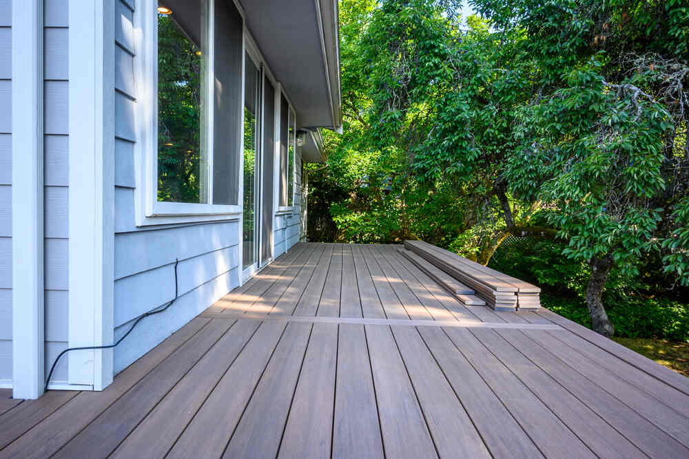 An outdoor deck under construction with trees in the background.