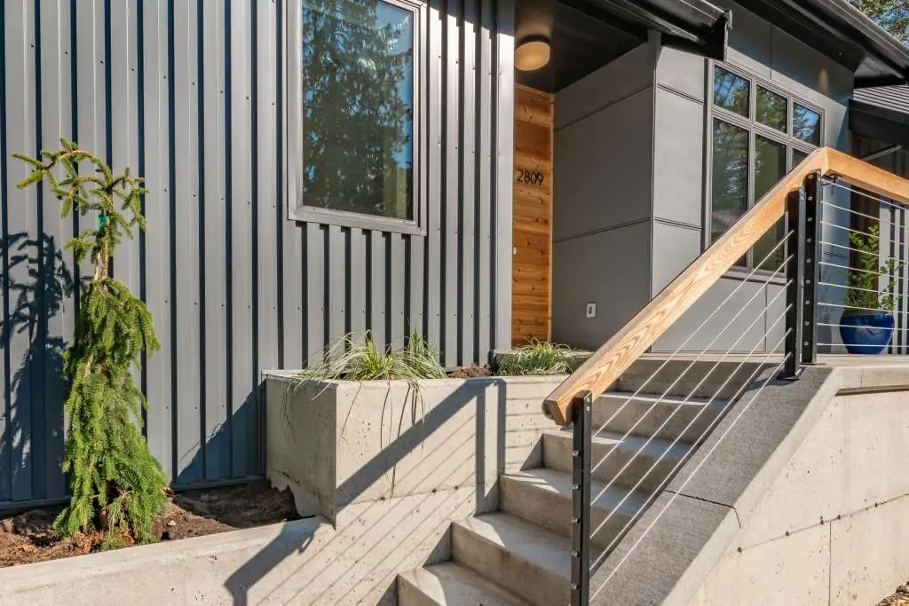 Front door entry exterior of a house with metal siding.