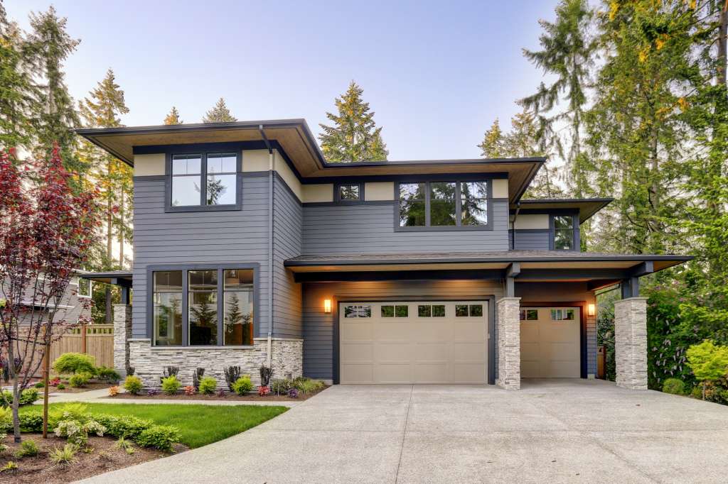 Entry exterior of a contemporary home with grey metal siding.