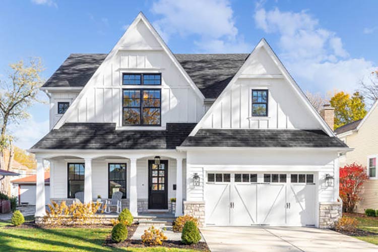 A farmhouse with white siding