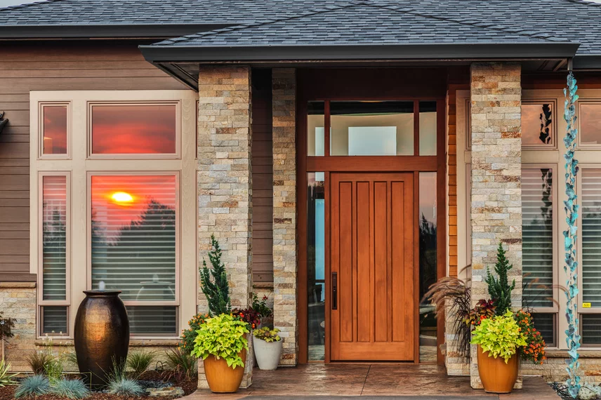 Home exterior with a sunset reflected in the windows